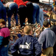 Fans climb over the steel barrier surrounding the pitch to avoid being crushed at Hillsborough Stadium. (Photo via David Cannnon/Getty).